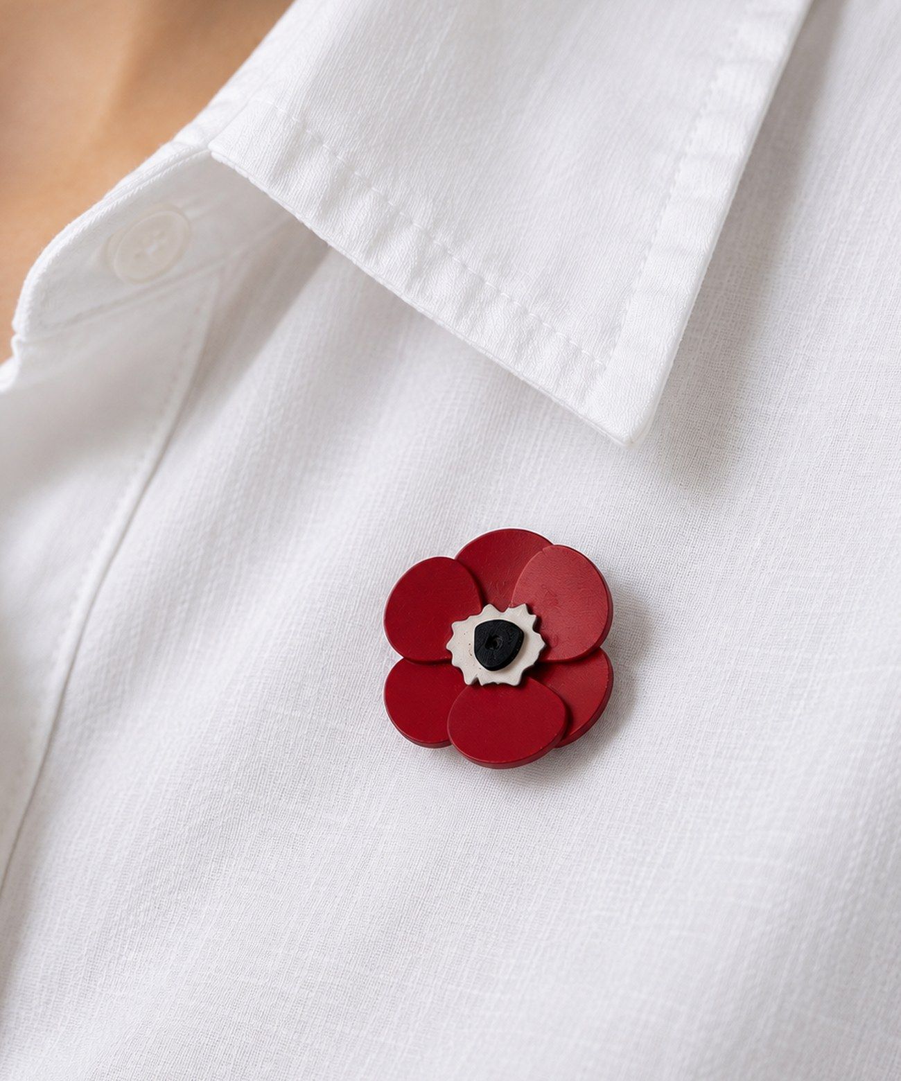 Open project: Anemone Pin, red anemone-shaped pin worn on a white shirt collar