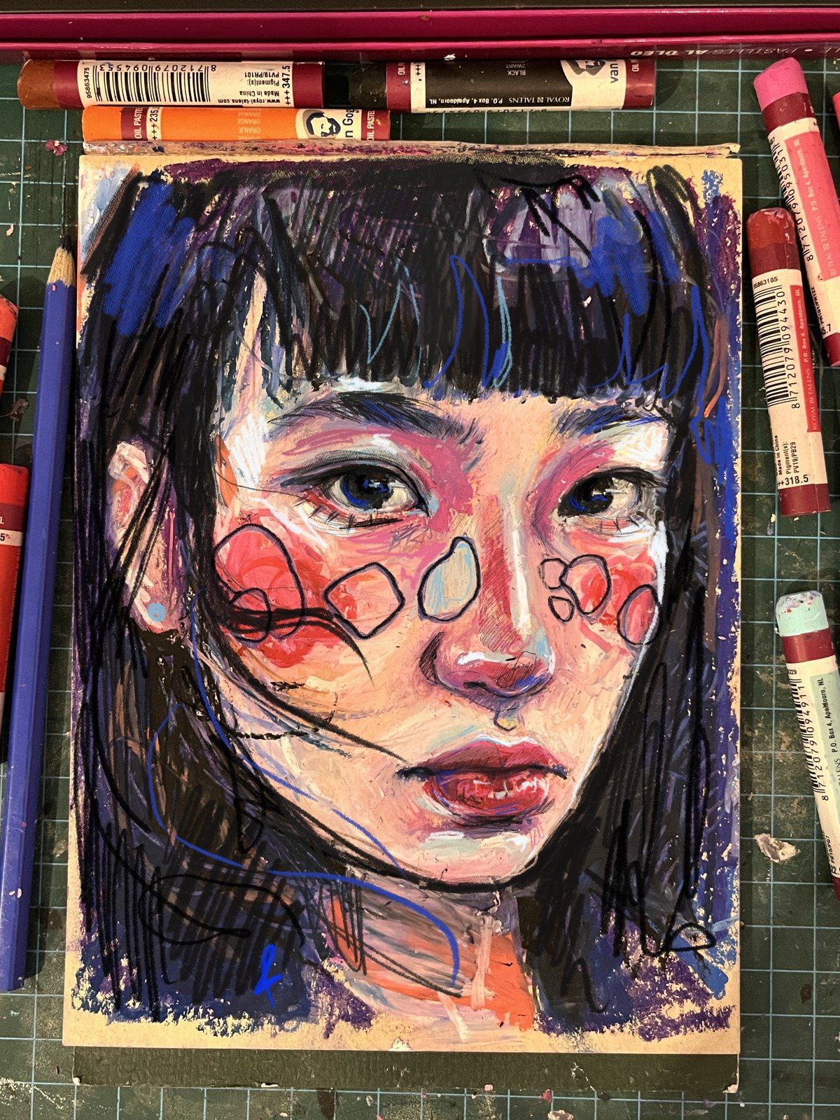 Oil pastel portrait of a girl with dark hair and colorful face markings, surrounded by pastel sticks