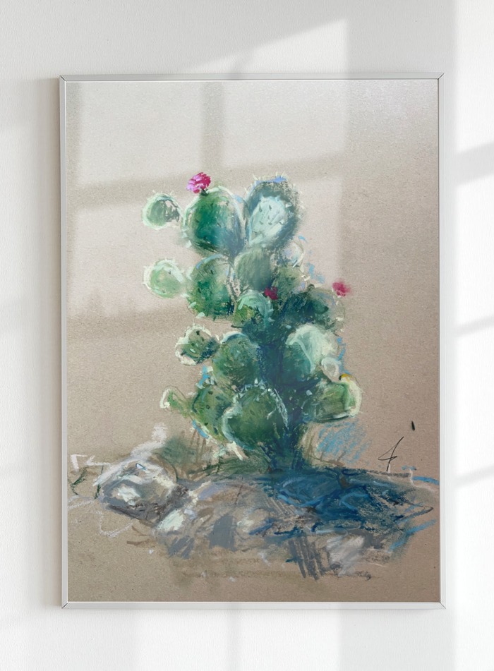 Mockup Studio result, framed pastel cactus drawing mounted on a wall