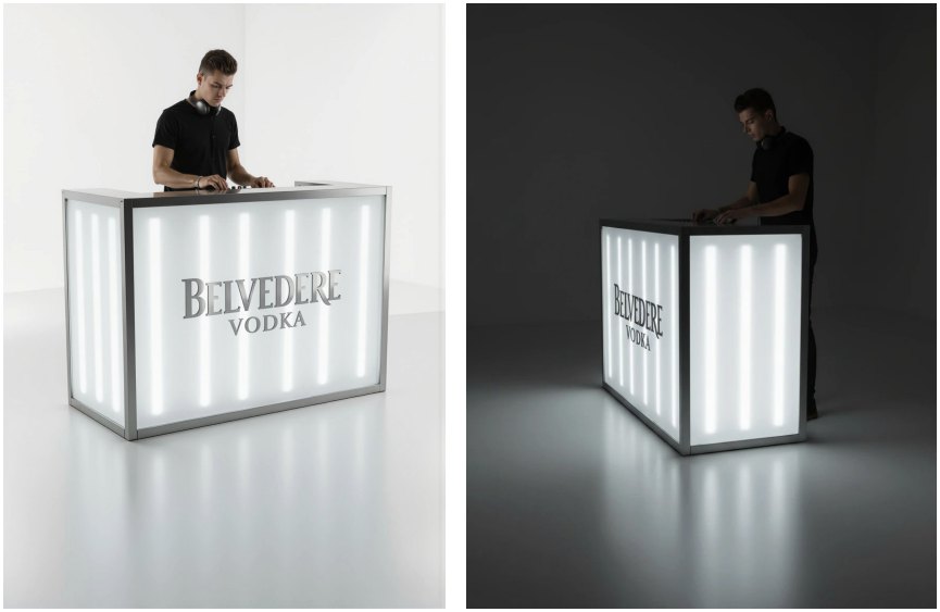 Direction B: a DJ booth of milky Perspex panels lit from inside by vertical white LEDs in a metal frame, with a Belvedere logo on the front, in light and dark settings