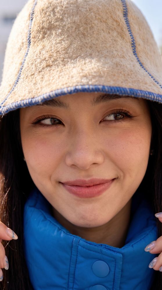 Bucket hat made from shed dog fur, close-up portrait wearing the felted hat