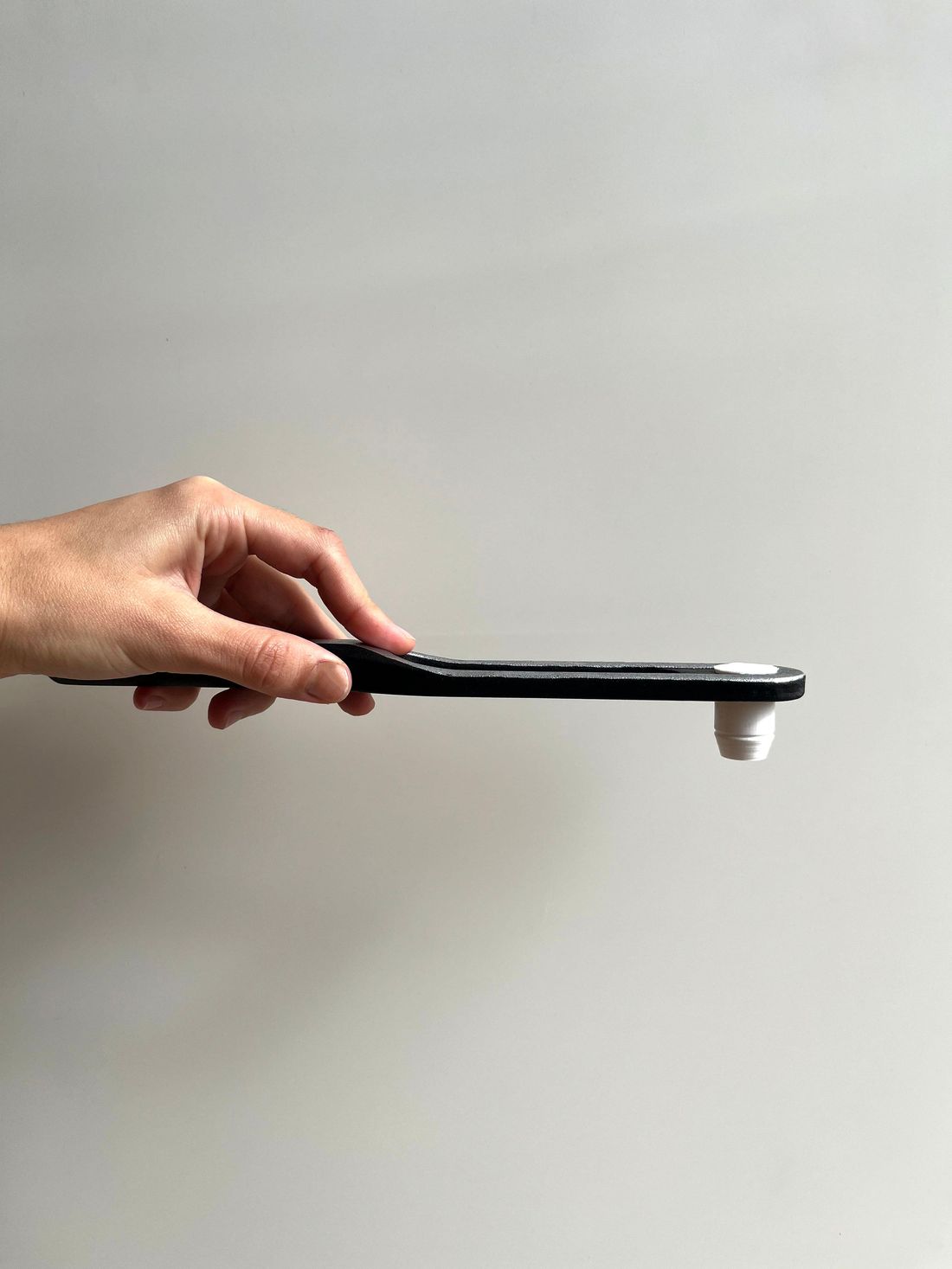 The pulley tool seen from the side, showing its thin profile and socket